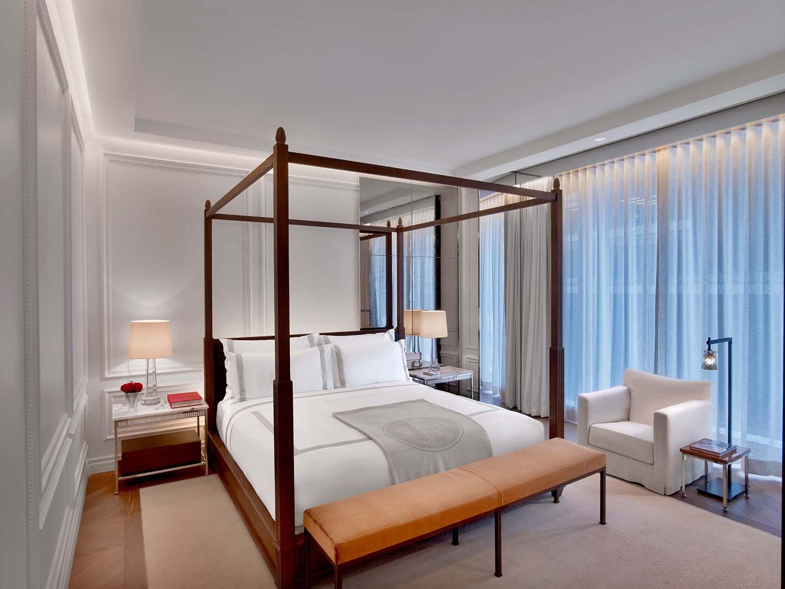 A white four post bed in the Prestige Suite of the Baccarat hotel
